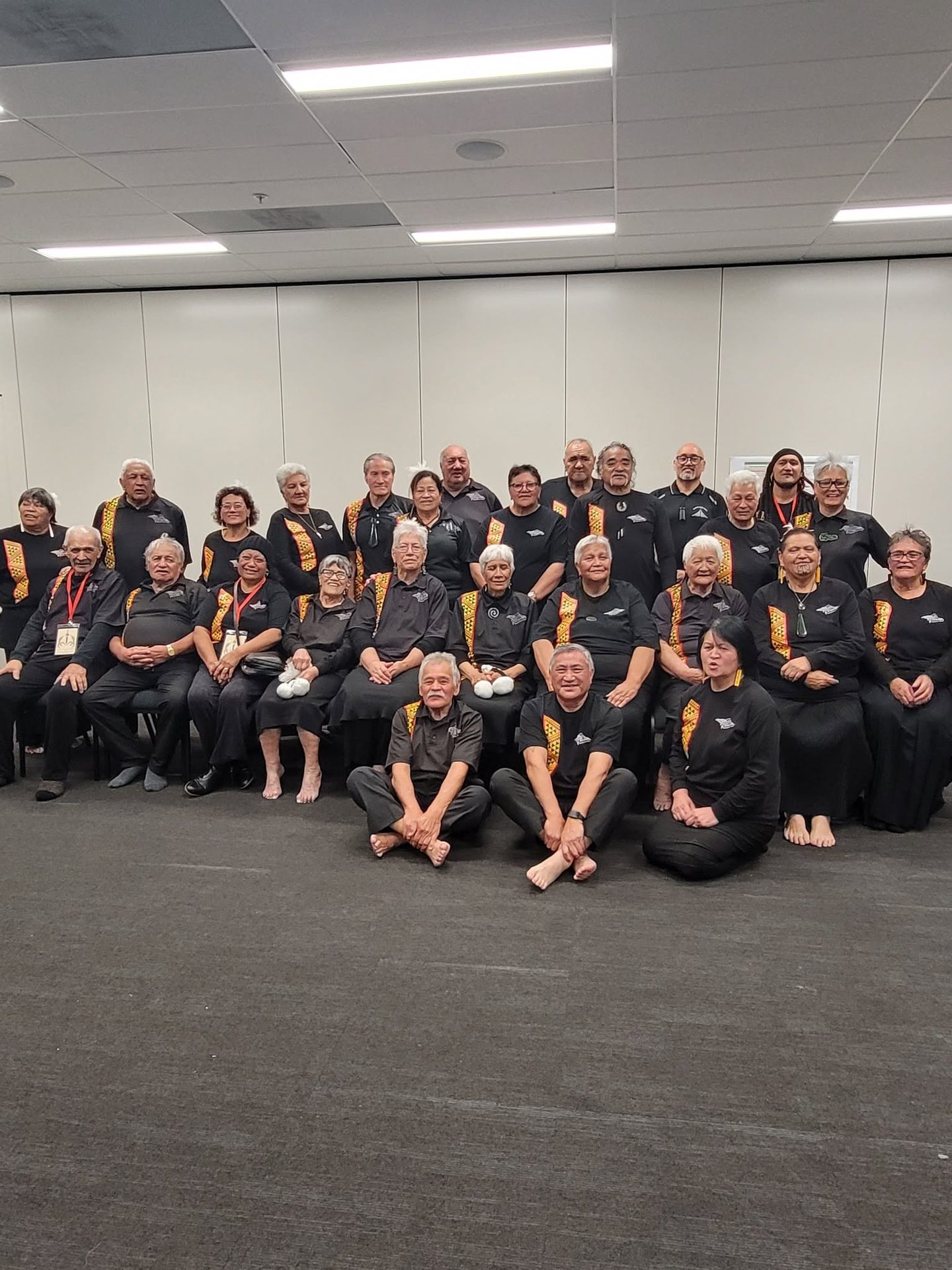Whānau posing together indoors, all smiles