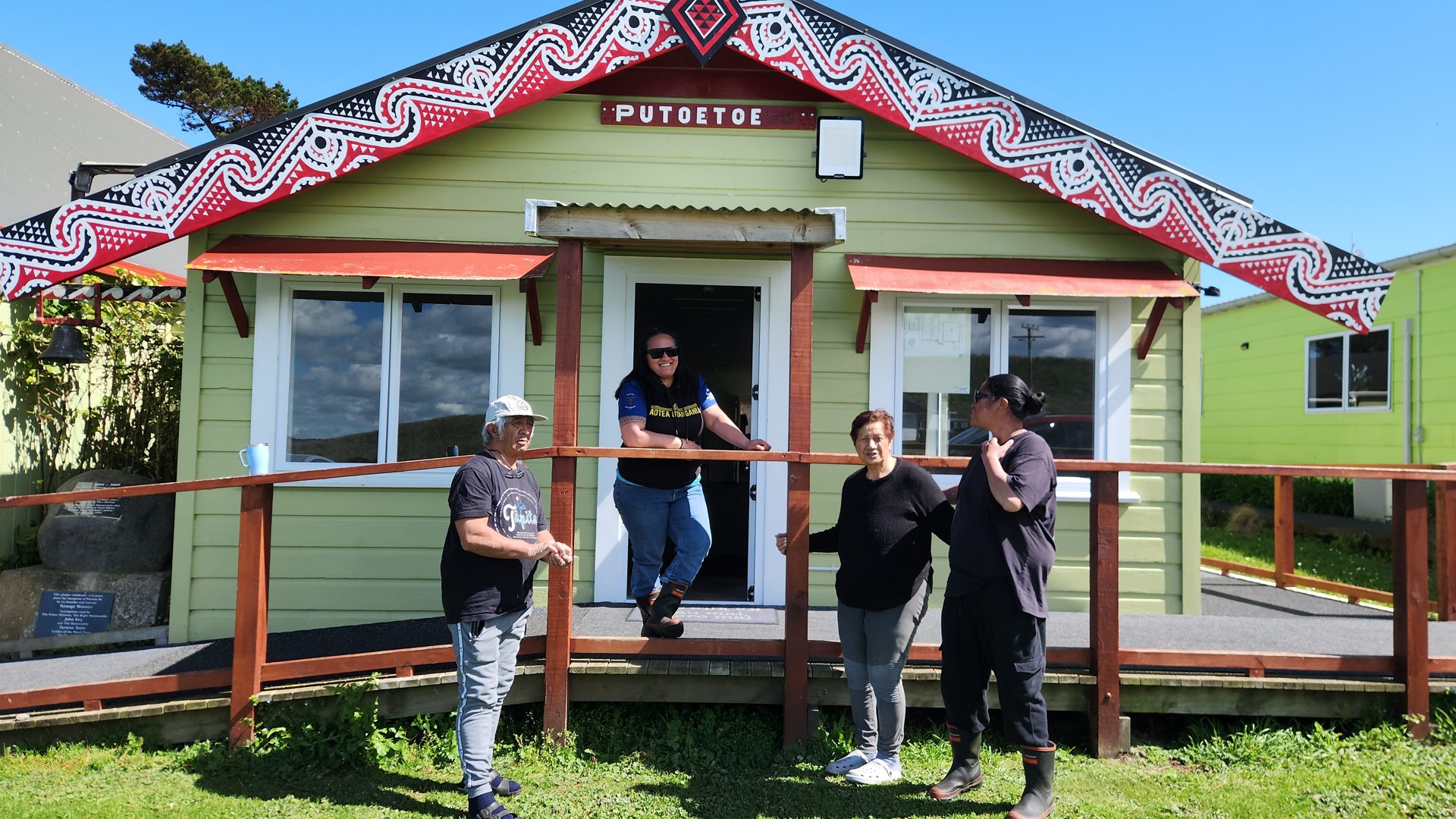 Smiling whānau at the front of the Putoetoe wharekai