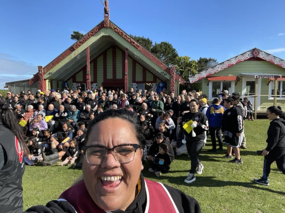 Smiling faces in front of the wharenui